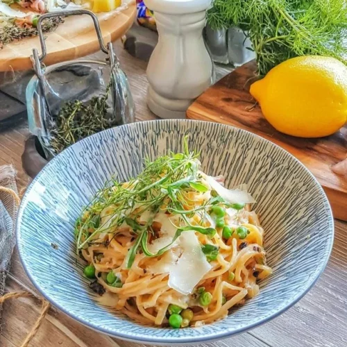 Pasta al limone med färska ärtor serverad i en tallrik