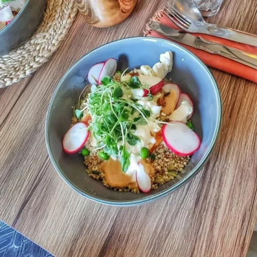 Quinoa bowl med rädisor, ärtor och fetaost i en skål