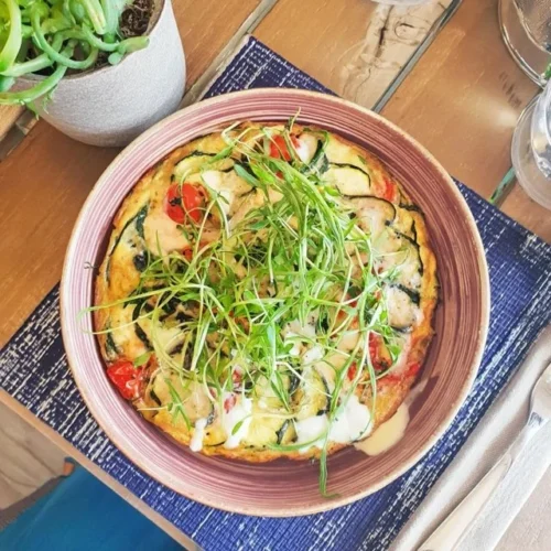 Zucchini-frittata med färska örter serverad på tallrik.